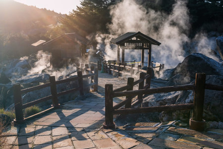 Mount Unzen Hell valley Jigoku and heavy sulfur gas at sunset, Nagasaki, Kyushu, Japan. Hot water and steam spout out by heated volcanic spring field.の写真素材