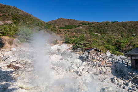 hot spring water and sulfur gasses by heated volcanic spring field at Jigoku hell valley of Mount Unzen against blue sky, Nagasaki, Kyushu, Japan. Famous travel destination for Kyushu in springtime.の写真素材