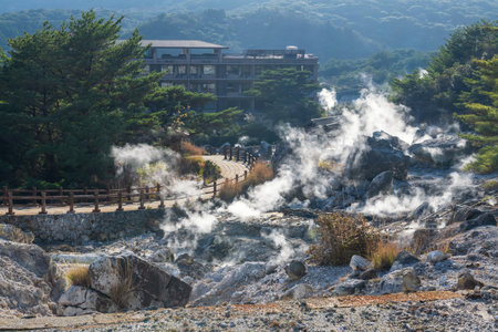 Top view of Hell valley Jigoku at Mount Unzen onsen hot springs resort, Nagasaki, Kyushu, Japan. Hot water, sulfur gas and steam spout out by heated volcanic spring field at sunset.の写真素材