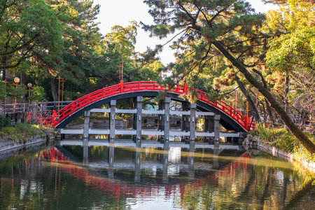 Drum Bridge arch or formally Sori Bashi at Sumiyoshi Grand Taisha Shrine with skyline reflection on pond, Osaka, Japan. Famous travel destination for sightseeing Kansai in fall season.の写真素材