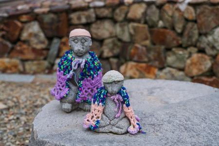 Monkey statues with scarf and hat in autumn at Ryuanji Kyakuden temple, Minoh waterfall park, Osaka, Japan. Famous travel destination for sightseeing Kansai in fall season.の写真素材
