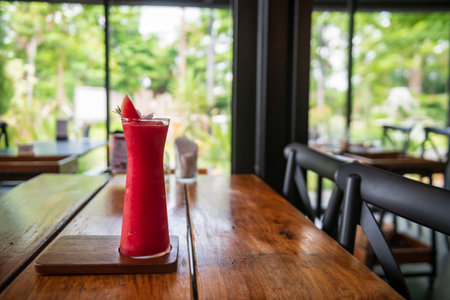 watermelon smoothie topped with mint leaves on a wooden table of cafe and restaurant.の写真素材