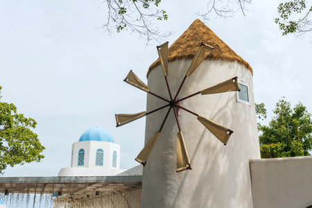 Windmill attached in modern building as restaurant by beach, Chonburi, Thailandの写真素材