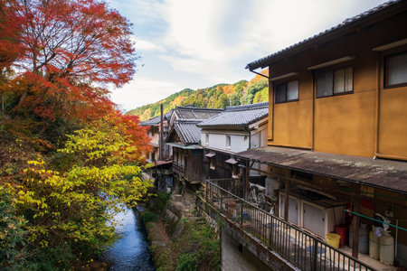 Japanese houses along canal and autumn foliage colors at Sakurai city, Nara, Japan. Famous town to visit Hase-dera or Hasedera Buddhist templeの写真素材