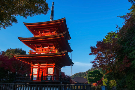 Kiyomizudera Koyasunoto Pagoda against autumn maple leaf colors and blue sky in December, Kyoto, Japan. Famous travel destination in Kansai especially in fall season.の写真素材