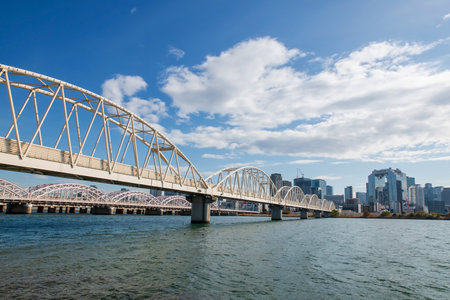 white bridges across Yodogawa River to Umeda sky tower against blue sky, Osaka, Japan. Famous travel destination for observation deck to  see top view city.の写真素材