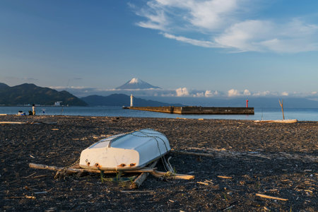 boat on miho beach black rock with lighthouse, mount Fuji and blue sky, Shimizu, Shizuoka Japan. Famous travel destination for fishing and sailing boat with beautiful view.の写真素材