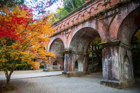 Nanzenji Temple brick aqueduct ladnscape with colorful maple leaf in autumn, Kyoto, Japan. Famous travel destination for tourist sightseeing Kansai in fall season.の写真素材