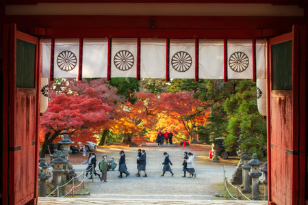Tamukeyama Hachimangu Shrine entrance gate with blur people and autumn foliage colors, Nara, Japan. Famous travel destination for sightseeing Kansai to see deer at fall in December.の写真素材