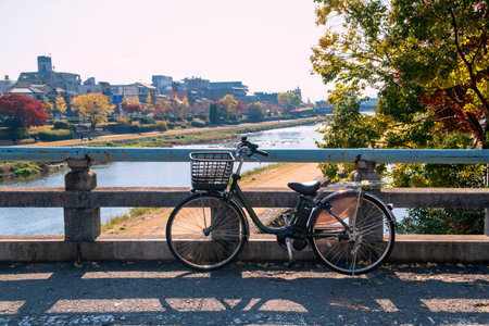 Bicycle on bridge across Kamo River with colorful maple leaf and city in autumn, Kyoto, Japan. Famous travel destination in Gion Districtの写真素材