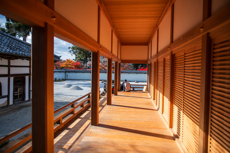 Foreign couple sit at Manshu-in Monzeki temple terrace with rock garden and autumn foliage colors, Kyoto, Japan. travel destination for tourist sightseeing Kansai for fall season.の写真素材