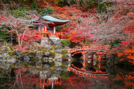 Pavilion pagoda and bridge in Daigo-ji or Diagoji temple with colorful autumn leaf and skyline reflection on pond, Kyoto, Japan. travel destination for tourist Kansai on peak fall in December.の写真素材