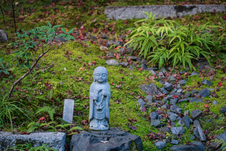 Jizo Buddist with rosary at garden of Nisonin temple, Arashiyama, Kyoto, Japan. Famous travel...