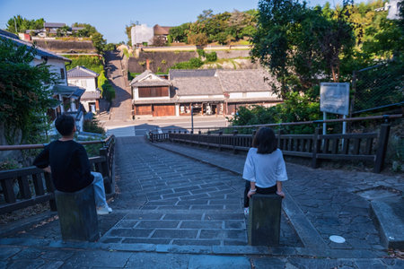 Brother and sister look at Iconic Suya no Saka slope with preserved Kitsuki castle town, Oita prefecture, Kyushu, Japan. Famous travel destination to sightseeing Kyushu east.の写真素材