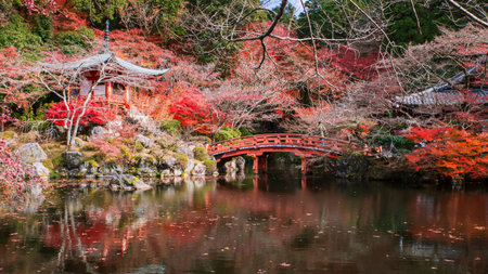 Tourist people across bridge to Pavilion pagoda of Daigo-ji temple with beautiful autumn garden colors, Kyoto, Japan. Travel destination for tourist in Kansai at fall in December.の写真素材