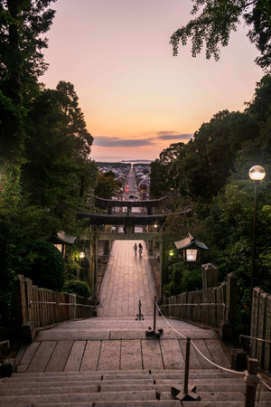 People at torii stone entrance gate on mountain hill and city view from Miyajidake Shrine temple at...