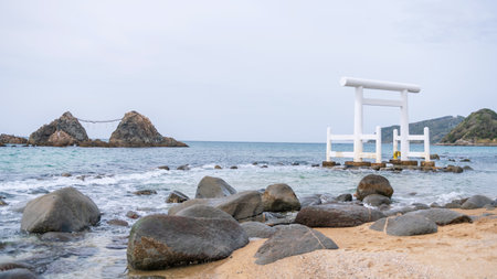 Big torii gate and Sakurai Futamigaura couple stones in Itoshima, Fukuoka Prefecture, Japan. It is one of famous travel destination or sightseeing spots in Itoshima.の写真素材