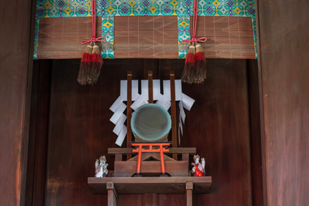 Small drum, inari kisune fox, red torii gate inside Hakozaki wooden shrine, Fukuoka, Japan. Famous travel destination for kami Hachiman with traditional architecture to pray for victory.の写真素材