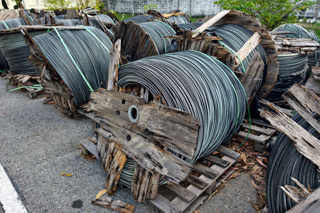 Electric galvanized steel wire on big wooden reels on street