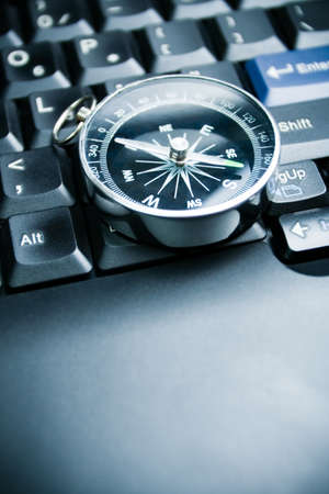 Computer keyboard and retro compass, business decisionの写真素材