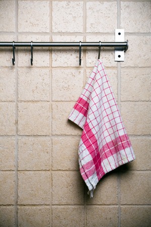 Kitchen utensils, cloth hanging alone on wall.の写真素材