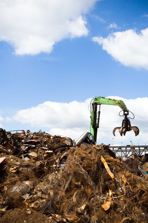 Metal recycling site over blue skyの写真素材