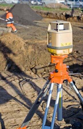 Geodesist's theodolite on road construction siteの写真素材