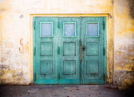 Green retro doors on concrete grunge wallの写真素材