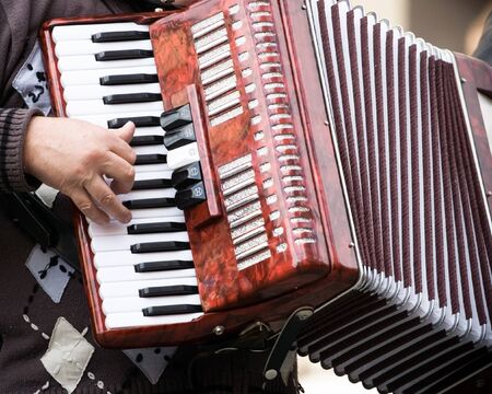 Musician playing on accordion on city streetの写真素材