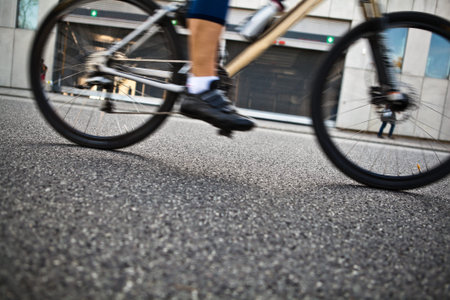Man riding a bike on city street, motion blur and selective focus