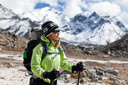 Young woman hiker hiking in Himalaya Mountains in Nepal