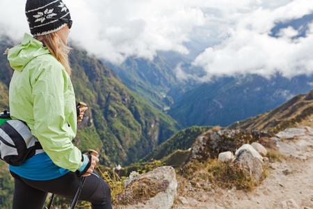 Young woman hiker hiking in Himalaya Mountains in Nepalの写真素材