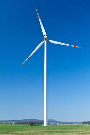 Wind turbine farm, alternative energy on green fieldの写真素材