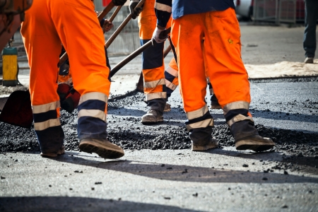 Workers on a road construction, industry and teamwork の写真素材