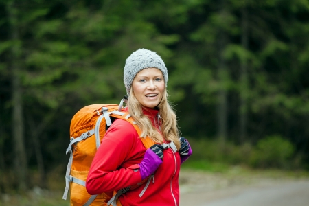 Beauty blond hiker walking with backpackの写真素材