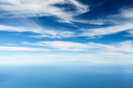 Ocean, sky and Tenerife island. Canary Islands on the blue ocean over cloudy beautiful sky. View from La Palma.の写真素材