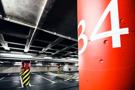 Parking garage underground interior, neon lights in dark industrial building, modern public constructionの写真素材