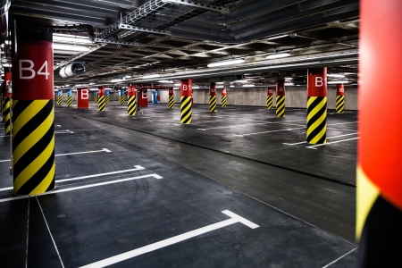 Parking garage underground interior, neon lights in dark industrial building, modern public constructionの写真素材