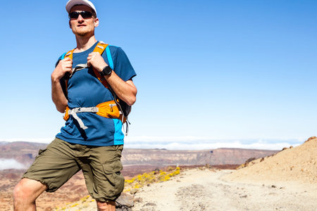 Trail runner, man walking or running in mountains with backpack. Running, sports, fitness and...