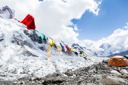 Khumbu glacier in Everest Base Camp, Himalaya Mountains, Nepal. Prayer flags and snow in camping site on rocks.の写真素材