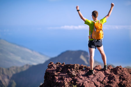 Hiker or trail runner man and success in mountains  Fitness and healthy lifestyle outdoors in summer...