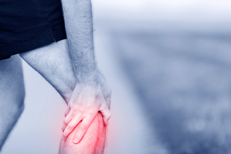 Runner leg and muscle pain during running training outdoors in summer nature, sport jogging physical injury, workout. Health and fitness conceptの写真素材