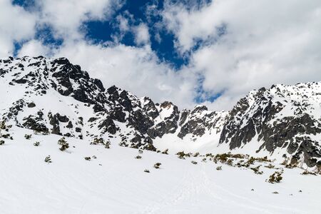 Mountain inspirational beautiful landscape in winter day, valley in Tatra Mountains. Mountain ridge over blue sunny sky, Poland.の写真素材
