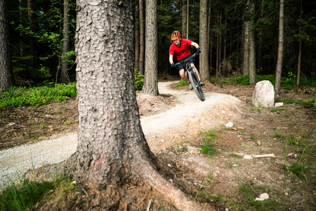 Mountain biker riding on bike in spring inspirational mountains landscape.の写真素材