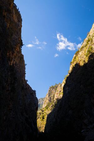 Mountains beautiful inspirational landscape in summer day. Samaria Gorge canyon in Crete Greece, Europe. Looking at view with silhouette of edge of the canyon.の写真素材