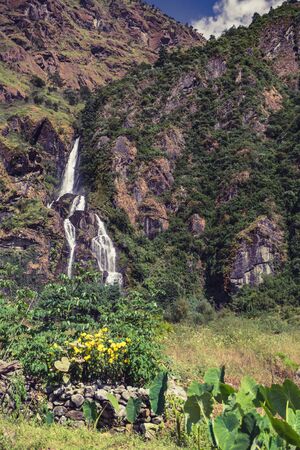 Beautiful Himalayan  Inspirational Landscape. Looking and Waterfall Mountains and valley with forest and green trees. Annapurna Himal Range on Annapurna Circuit Trek. Autumn season in Nepal, Asia.の写真素材
