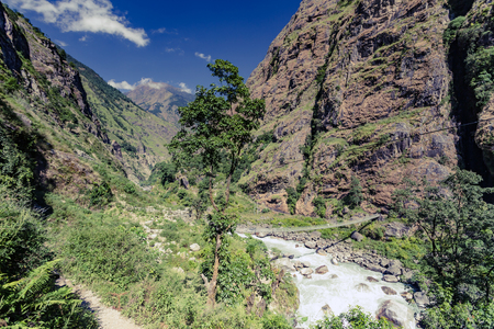 Beautiful Himalayan Inspirational Landscape. Looking and Mountains and valley with forest and green trees. Annapurna Himal Range on Annapurna Circuit Trek. Autumn season in Nepal, Asia.の写真素材
