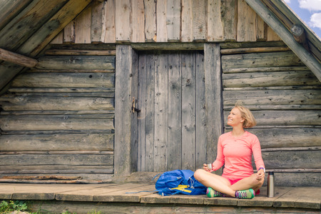 Young woman hiker camping, drink coffee or tea in beautiful Tatra mountains on hiking tripの写真素材