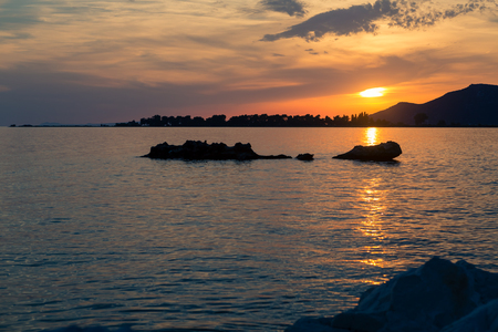 Inspirational beautiful mountains landscape with sea, coast, beach and rocks, mountains in background atsunset in Croatia.の写真素材