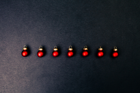 Christmas red shiny balls flat layout on dark background. Top closeup view with copy space.の写真素材